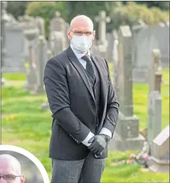  ??  ?? Funeral director Cameron McGillivra­y wears PPE as he helps families say goodbye to loved ones