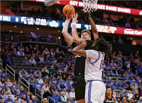  ?? ?? UConn’s Donovan Clingan attempts a shot as Seton Hall’s Jaden Bediako defends during the first half at Prudential Center on Wednesday in Newark, N.J.