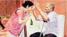  ??  ?? External Affairs Minister Sushma Swaraj seeks blessings from a veteran of Azad Hind Fauz during ASEAN-INDIA Pravasi Bharatiya Divas function in Singapore on Sunday