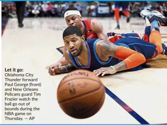  ??  ?? Let it go: Oklahoma City Thunder forward Paul George (front) and New Orleans Pelicans guard Tim Frazier watch the ball go out of bounds during the NBA game on Thursday.