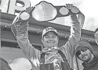  ?? ISAAC RITCHEY/AP ?? Jacob Runyan, holding up the champion's belt, and Chase Cominsky, at the Rossford Walleye Roundup Tournament in Rossford, Ohio, on April 16, 2022.