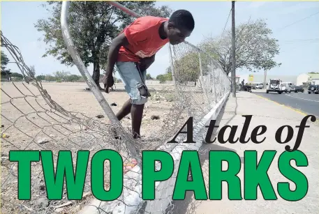  ?? PHOTOS BY JERMAINE BARNABY/PHOTOGRAPH­ER ?? A man walks through an opening in the fence at the National Heroes Park.