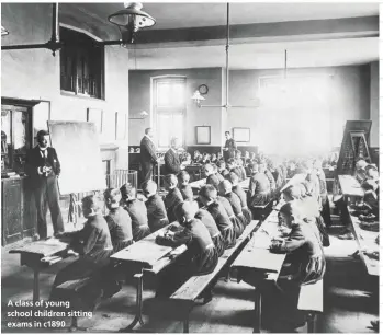  ??  ?? A class of young school children sitting exams in c1890