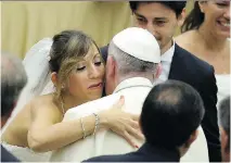  ?? FILIPPO MONTEFORTE/AFP/GETTY IMAGES ?? Pope Francis is greeted by newlyweds during a general audience at the Vatican on Wednesday.