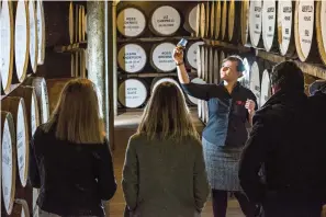  ?? East London Liquor Company via AP ?? ■ People are guided in 2018 during a cellar tour of the Dewer’s Distillery in Aberfeldy, the Scottish Highlands. Scotch whisky has been produced there since 1898, and traditiona­l whisky tastings and a whisky and chocolate tasting tour are available.