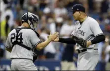  ?? CHRIS O’MEARA — THE ASSOCIATED PRESS ?? Yankees pitcher Dellin Betances, right, celebrates with Gary Sanchez after Sunday’s win.