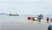  ?? ?? Rescuers at scene of the crashed passenger aircraft on the shores of Lake Victoria, western Tanzania.