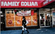  ?? SPENCER PLATT/GETTY IMAGES ?? A woman walks by a Family Dollar store in New York City in 2018. As the income gap between rich and poor continues to grow, dollar stores have become increasing­ly popular.