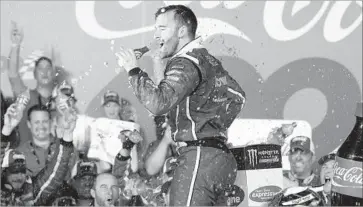  ?? Chuck Burton Associated Press ?? AN ECSTATIC Austin Dillon celebrates in Victory Lane after winning the Coca-Cola 600 at Charlotte Motor Speedway. NASCAR’s longest race was delayed about 1 hour, 40 minutes because of inclement weather.