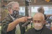  ?? MORRY GASH/AP ?? Owner Paul Furrer cuts the hair of Louis Rigano at Rick’s Barber Shop on Thursday in Waukesha, Wisconsin.