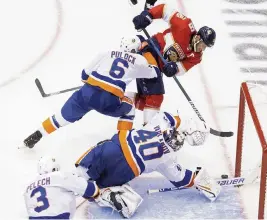  ?? CHRIS YOUNG Associated Press ?? Islanders goalie Semyon Varlamov dives to turn away a scoring bid by Panthers captain Aleksander Barkov. The Panthers never led in the game.