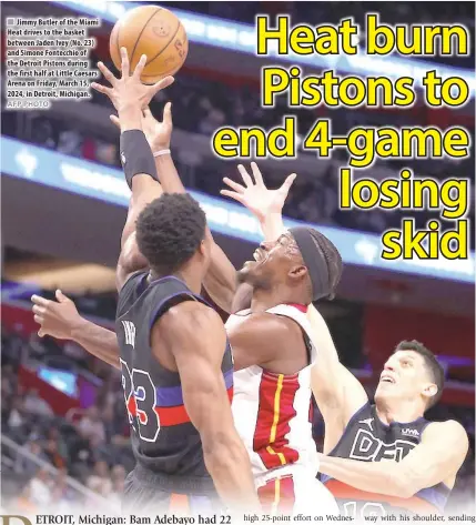  ?? AFP PHOTO ?? Jimmy Butler of the Miami Heat drives to the basket between Jaden Ivey (No. 23) and Simone Fontecchio of the Detroit Pistons during the first half at Little Caesars Arena on Friday, March 15, 2024, in Detroit, Michigan.