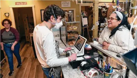  ?? Arnold Gold/Hearst Connecticu­t Media ?? Eric Johnson, center, of Chester takes the lunch order for Kimberly Taylor, program director of A Little Compassion, at The Nest Coffee House in Deep River on February 21, 2023.