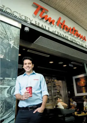  ?? CITIZEN NEWS SERVICE PHOTO ?? Alex Macedo, the president of Tim Hortons, poses for a photograph at the Hockey Hall of Fame Tim Hortons location in Toronto on Thursday.