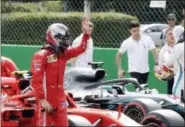  ?? LUCA BRUNO — THE ASSOCIATED PRESS ?? Ferrari driver Kimi Raikkonen of Finland celebrates after setting a pole position in the qualifying session at the Monza racetrack, in Monza, Italy, Saturday.