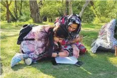  ?? Sana Jamal/Gulf News ?? Students take part in soil testing activity as part of Earth Day event in Islamabad.