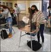  ?? JESSICA HILL / AP ?? Students in a science class clean their work areas. The CDC says students can now sit 3 feet apart in classrooms.