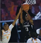  ?? SAUL YOUNG — KNOXVILLE NEWS SENTINEL VIA AP, POOL ?? Connecticu­t’s Christyn Williams shoots while defended by Tennessee’s Jordan Walker (4) during Thursay’s game.