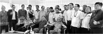  ??  ?? Henry (seated centre), Tenewi (seated left) and Granda (seated right) during a photo-call with other participan­ts of the forum on Feb 18.