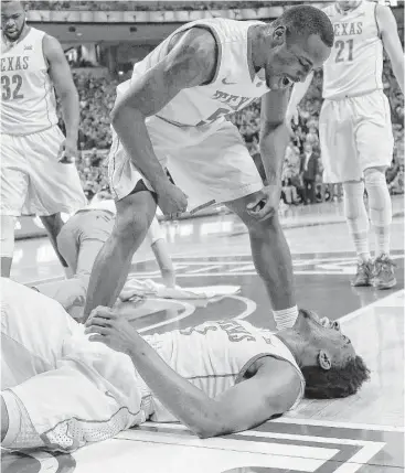  ?? Chris Covatta / Getty Images ?? Texas’ Kendal Yancy, top, and Isaiah Taylor get fired up after Taylor scored during Tuesday night’s victory over West Virginia. Taylor led the Longhorns with 23 points.