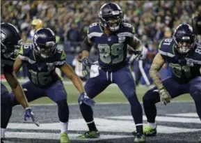  ?? ELAINE THOMPSON - THE ASSOCIATED PRESS ?? Seattle Seahawks wide receiver Doug Baldwin (89) takes part in a touchdown celebratio­n with Tyler Lockett, left, and Nick Vannett, right, after Baldwin caught a pass for a touchdown against the Green Bay Packers during the first half of an NFL football game, Thursday, Nov. 15, 2018, in Seattle.