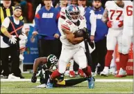  ?? Steve Luciano / Associated Press ?? New York Giants running back Saquon Barkley (26) evades a tackle from Green Bay Packers safety Darnell Savage Sunday at Tottenham Hotspur Stadium in London.