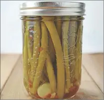  ?? CANADIAN PRESS PHOTO ?? Zip up a caesar with a tangy pickled green bean, an easy canning recipe for beginners. You’ll never go back to a celery stick, says Amy Bronee, author of ‘The Canning Kitchen: 101 Simple Small Batch Recipes’.