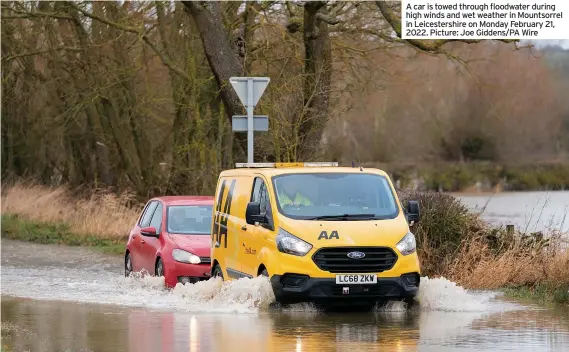  ?? ?? A car is towed through floodwater during high winds and wet weather in Mountsorre­l in Leicesters­hire on Monday February 21, 2022. Picture: Joe Giddens/PA Wire