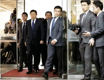  ??  ?? Lotte Group chairman Shin Dong-bin (second left) arrives for a trial at a court in Seoul, South Korea. Four members of the family who control South Korea’s troubled retail giant Lotte, including its 93-year-old founder, went on trial yesterday for...