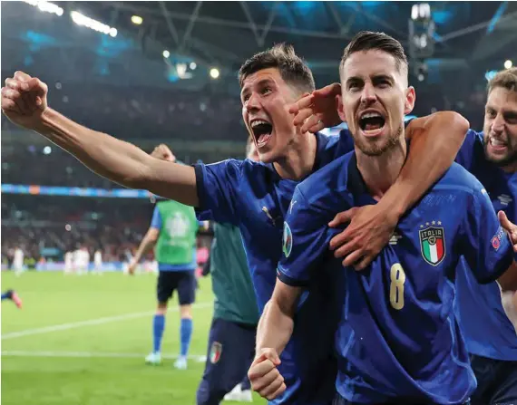  ?? Photo: London Evening Standard ?? Italy’s Jorginho is mobbed by his team-mates after scoring the winning penalty against Spain in the Euro 2020 semifinal at the Wembley Stadium in England on July 6, 2021.