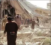  ?? PICTURE: AAMAQ NEWS AGENCY VIA AP ?? In this undated frame grab from a video posted online on May 29 by the Aamaq News Agency, a media arm of the Islamic State group, people inspect damage from airstrikes and artillery shelling in the northern city of Raqqa, Syria.