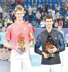  ?? — AFP photo ?? Serbia's Novak Djokovic and South Africa Kevin Anderson pose at the end of the Mubadala World Tennis Championsh­ip 2018 in Abu Dhabi, on December 29, 2018.