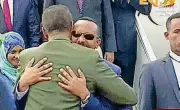 ?? [PHOTO BY ERITV VIA AP] ?? Ethiopia’s Prime Minister Abiy Ahmed, background center, is welcomed Sunday by Eritrea’s President Isaias Afwerki as he disembarks the plane, in Asmara, Eritrea. With laughter and hugs, the leaders of longtime rivals met for the first time in nearly...