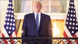  ?? Win McNamee / Getty Images ?? President Donald Trump stands on the Truman Balcony after returning to the White House from Walter Reed National Military Medical Center on Monday. On Saturday, Trump will hold a public event and address the crowd from the balcony.