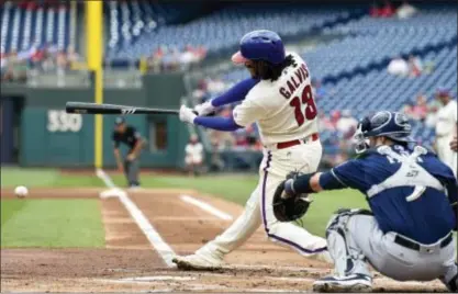  ?? DERIK HAMILTON — THE ASSOCIATED PRESS ?? The Phillies’ Freddy Galvis follows through on his swing the Brewers’ Jonathan Villar. in the first inning. Galvis reached base on an error by