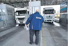  ?? ?? A Bulgarian customs officer inspects trucks at border checkpoint.
