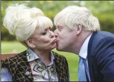  ?? ASSOCIATED PRESS FILES ?? British actress Barbra Windsor is kissed by British Prime Minister Boris Johnson, in 10 Downing Street, London, to promote Dementia Care last year. Windsor, whose seven-decade career ranged from cheeky film comedies to the soap opera “EastEnders” died Thursday at age 83.