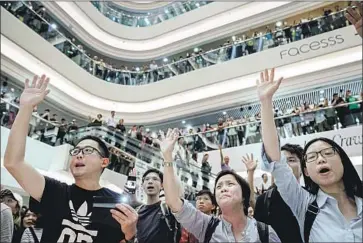  ?? Marcus Yam Los Angeles Times ?? CROWDS assembled Friday at Times Square Shopping Center and other Hong Kong malls to sing “Glory to Hong Kong,” a song that was first posted Aug. 31. In just weeks it’s become a symbol of the protest movement.