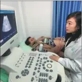  ?? YANG DONG / FOR CHINA DAILY ?? Li Yue, who is pregnant with her second child, has an ultrasound examinatio­n at the community health center in Xiangyang, Hubei province.