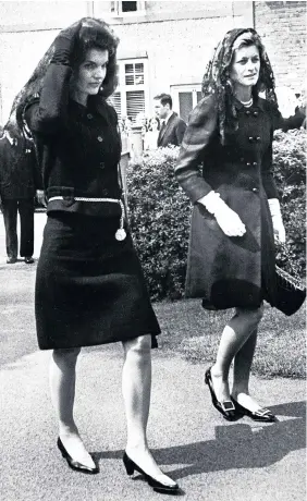  ??  ?? > June 1967: Jacqueline Kennedy, widow of President John F Kennedy, arrives at Owestry Roman Catholic Church for the funeral of Lady Harlech, Sylvia Ormsby-Gore, accompanie­d by her sister in law Eunice Kennedy Schriver