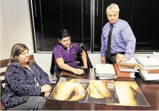  ?? Melissa Phillip / Houston Chronicle file ?? Guadalupe Suquet and her son, Cesar Jr., confer with attorney Mark Montgomery, right, on Jan. 15 about the photos showing Cesar’s injuries from being beaten by a Pasadena ISD school resource officer. The officer used a metal nightstick to strike Cesar...