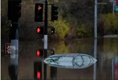  ?? GREGORY BULL — THE ASSOCIATED PRESS ?? A car sits along a flooded road during a rain storm Monday in San Diego.