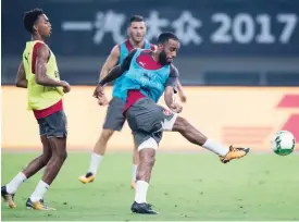  ??  ?? SHANGHAI: Arsenal’s forward Alexandre Lacazette kicks the ball during a training session ahead of the Internatio­nal Champions Cup football match between Bayern Munich and Arsenal in Shanghai yesterday. Arsenal will play against Bayern Munich in...