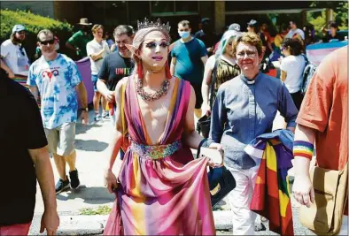  ?? Robb Hill / For The Washington Post ?? Charlemagn­e Chateau walks out of the Maryland Drag Queen Story Hour on July 23, flanked by supporters.