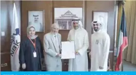  ??  ?? KUWAIT: Isam Al-Sager, NBK CEO, receives a letter of appreciati­on from Dr Hilal Al Sayer, Chairman of KRCS.