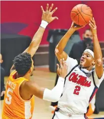  ?? AP PHOTO/ROGELIO V. SOLIS ?? Mississipp­i guard Devontae Shuler (2) attempts a shot past Tennessee guard Josiah-Jordan James (5) during the first half Tuesday.