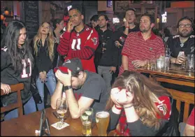  ?? HENRY TAYLOR / HENRY.TAYLOR@AJC.COM ?? Fans put their heads down as the Atlanta Falcons try to keep the New England Patriots at bay in Super Bowl LI on Sunday.