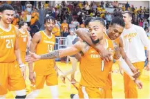  ?? MARK WALLHEISER/ ASSOCIATED PRESS ?? Tennessee guard Lamonte Turner is congratula­ted by teammates after hitting a game-winning shot Saturday against VCU.