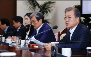  ?? AP/Yonhap/BAE JAE-MAN ?? South Korean President Moon Jae-in (right), shown Monday in Seoul, has urged Japan to drop the trade restrictio­ns, which he described as politicall­y motivated.