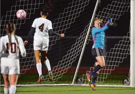  ?? TIM MARTIN/THE DAY ?? Plainfield’s Izzy Newbury (4) heads the ball into the net past a defenseles­s NFA goalie Allyson Knorr-Anderson in the second sudden death overtime to give the top-seeded Panthers a 1-0 win over the No. 5 Wildcats in the semifinals of the ECC girls’...